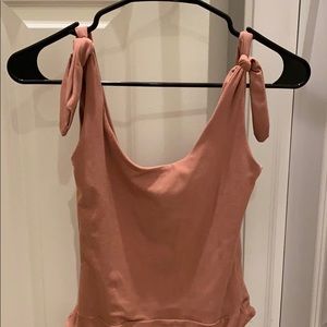 Dusty rose colored body suit.